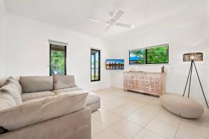 a living room with a couch and a ceiling fan at The Beachwood Nest in Broome
