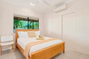 a bedroom with a large bed and a window at The Beachwood Nest in Broome +28 photos