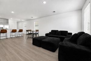 a living room with a couch and a table and chairs at 3BR Near Gruene Historic District, Comal, and Guadalupe Rivers & Schlitterbahn in New Braunfels