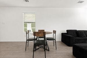 a table and chairs in a living room with a couch at 3BR Near Gruene Historic District, Comal, and Guadalupe Rivers & Schlitterbahn in New Braunfels