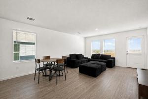 a living room with a couch and a table and chairs at 3BR Near Gruene Historic District, Comal, and Guadalupe Rivers & Schlitterbahn in New Braunfels +31 photos