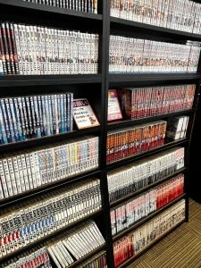 a shelf full of dvds and video games at Kuretake-Inn Kakegawa in Kakegawa