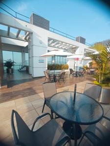 a patio with a glass table and chairs at Departamento 68 river 2 in Guayaquil