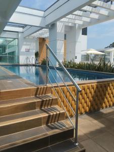 a swimming pool with stairs in a building at Departamento 68 river 2 in Guayaquil