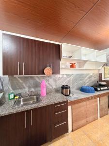a kitchen with a sink and a counter top at Casa Saturnino Private Staycation 