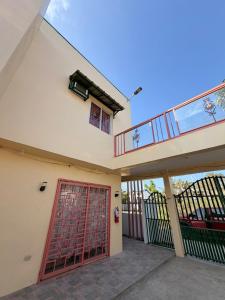 a house with a red door and a balcony at Casa Saturnino Private Staycation 