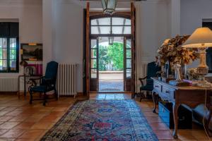 a hallway with a table and chairs and an open door at Mezquida del puerto in Jávea +23 photos