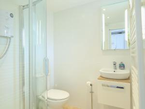 a white bathroom with a toilet and a sink at 4 Thornlea Mews in Kingsbridge +24 photos