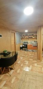 a living room with a table and a kitchen at Departamento Tepual in Llanquihue