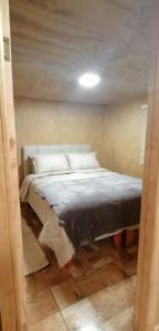 a bedroom with a bed in a room at Departamento Tepual in Llanquihue
