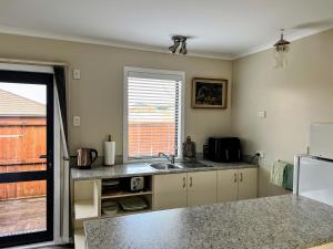 a kitchen with a sink and a window at Almost Country in Taupo