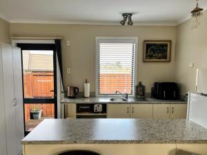 a kitchen with a sink and a counter top at Almost Country in Taupo +5 photos
