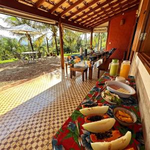 a table with plates of food on top of it at Pousada & Chalés Quinta da Nascente - Serra da Canastra in Delfinópolis