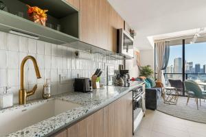 a kitchen with a sink and a counter top at Miami Luxe Sky 27 Skyline View Stunning Water & City Lights View, Resort Pool,Gym,Spa Restaurants in Miami +38 photos
