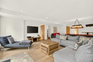 a living room with two couches and a tv at Fiddler Lake Resort - Deer 87 in Mille-Isles