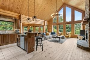 a kitchen and living room in a log cabin at Fiddler Lake Resort - Deer 87 in Mille-Isles