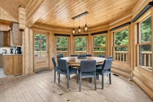 a dining room with a table and chairs at Fiddler Lake Resort - Deer 87 in Mille-Isles +23 photos