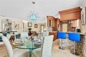 a dining room and living room with a table and chairs at Luxury Waterfront Villa, With Private Hot Tub, Beachs, Aventura Mall Casinos, Restaruants in Hallandale Beach