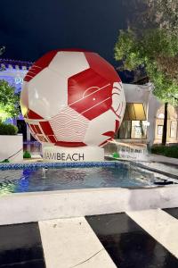 a large soccer ball sitting next to a pool at Luxury Waterfront Villa, With Private Hot Tub, Beachs, Aventura Mall Casinos, Restaruants in Hallandale Beach