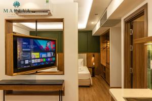 a room with a large flat screen tv on a wall at MAREVA KHEM BEACH HOTEL - Free Beach Shuttle in Phú Quốc +171 photos