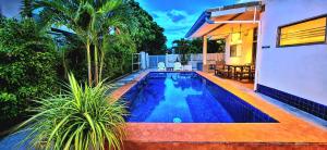 a swimming pool in the backyard of a house at Pranburi Private Pool Villa Baan Prae by Baan Chaylay in Pran Buri +37 photos