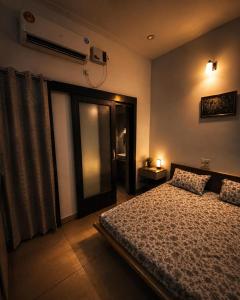 a bedroom with a bed and a large window at The Golden Window Villa in Amritsar