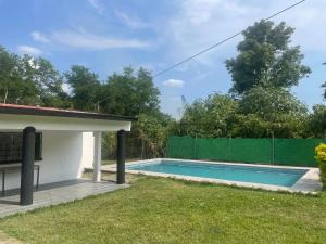 a swimming pool in the backyard of a house at Casa fraccionamiento colonos Ticuman in Ticumán