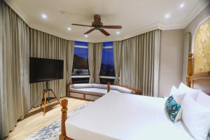 a hotel room with a bed and a television at Hotel Arif Castle, Nainital in Nainital