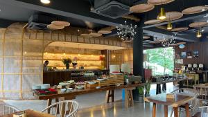 a restaurant with tables and chairs and a kitchen at Evergreen Forest Retreat Zhangjiajie, Near National Forest Park Avator Park, Luxury Nature Escape, Free Airport&Train Shuttle Service & Travel itinerary, English Speaking Butler in Zhangjiajie