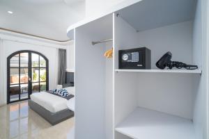 a living room with a bed and a shelf with a phone at Majestic Balangan in Uluwatu