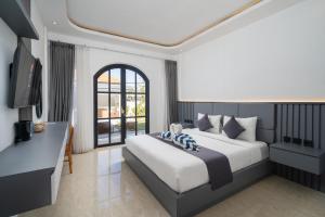 a bedroom with a large bed and a television at Majestic Balangan in Uluwatu +54 photos