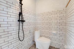 a bathroom with a shower and a toilet at Suwehan Rey Cliff House in Nusa Penida +44 photos