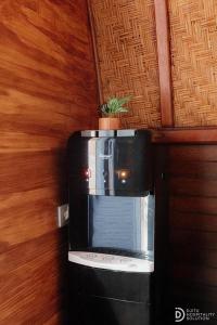 a television with a plant on top of it at Suwehan Rey Cliff House in Nusa Penida
