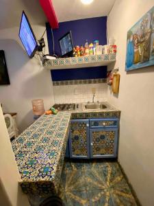 a small kitchen with a sink and a counter top at Suites El Refugio zona Céntrica frente al Tren ligero linea 1 in Guadalajara +94 photos