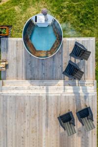 an overhead view of a swimming pool and two chairs at Cedar - Luxury Oceanview Cottage with Hot Tub & Private Beach Access near Cabot Trail in Chimney Corner