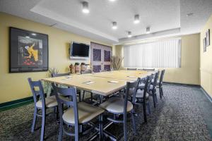 a large conference room with a long table and chairs at AmericInn by Wyndham Sioux Falls in Sioux Falls