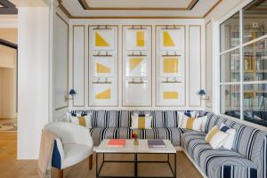 a living room with a couch and a table at MiM Sotogrande member of Meliá Collection in Sotogrande