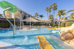 a swimming pool with a fountain in a resort at SOL by Meliá Príncipe in Torremolinos