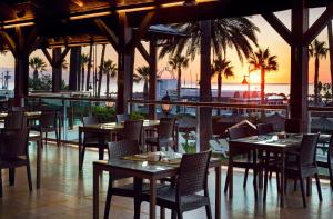 a restaurant with tables and chairs with a view of the ocean at SOL by Meliá Príncipe in Torremolinos +58 photos