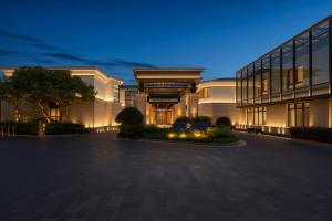 a rendering of a building at night at Greenland Mansion in Shanghai
