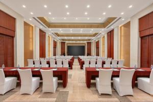 a large room with long tables and white chairs at Greenland Mansion in Shanghai +79 photos