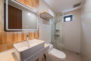 a bathroom with a sink and a toilet and a mirror at RubyHome in Thôn Nguyệt Biều +60 photos