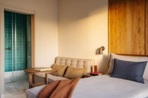 a bedroom with a bed and a chair and a table at ME by Meliá Malaga in Málaga