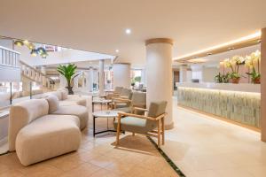a lobby with a waiting area with chairs and tables at SOL by Meliá Sun Beach Apartamentos in Adeje