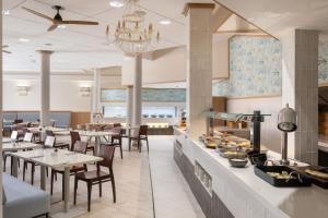 a dining room with tables and chairs and a buffet at SOL by Meliá Sun Beach Apartamentos in Adeje +57 photos