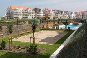 a view of a park with a pool and houses at Villa Moya in Nieuwpoort