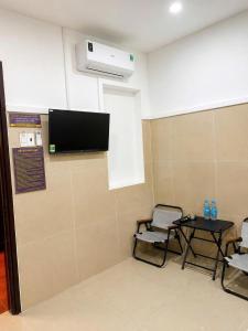a room with two chairs and a table and a tv at Cảnh Việt Hotel in Tây Ninh