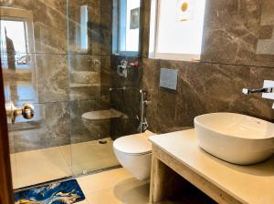 a bathroom with a toilet and a sink and a shower at The Boho Shantii Stays in Bhīm Tāl +28 photos