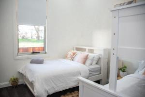 a bedroom with two beds and a window at The Guesthouse in Terang