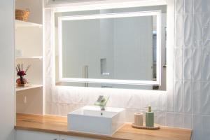 a bathroom with a white sink and a window at The Guesthouse in Terang +23 photos